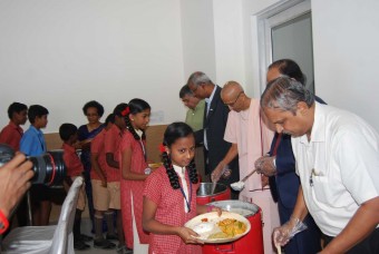 Dignitaries serve nutritious meals to the children